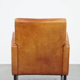 Characteristic sheepskin design armchair in beautiful warm cognac colours