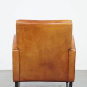 Characteristic sheepskin design armchair in beautiful warm cognac colours