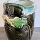 Antique ceramic vase by De Bruyn with floral decoration.