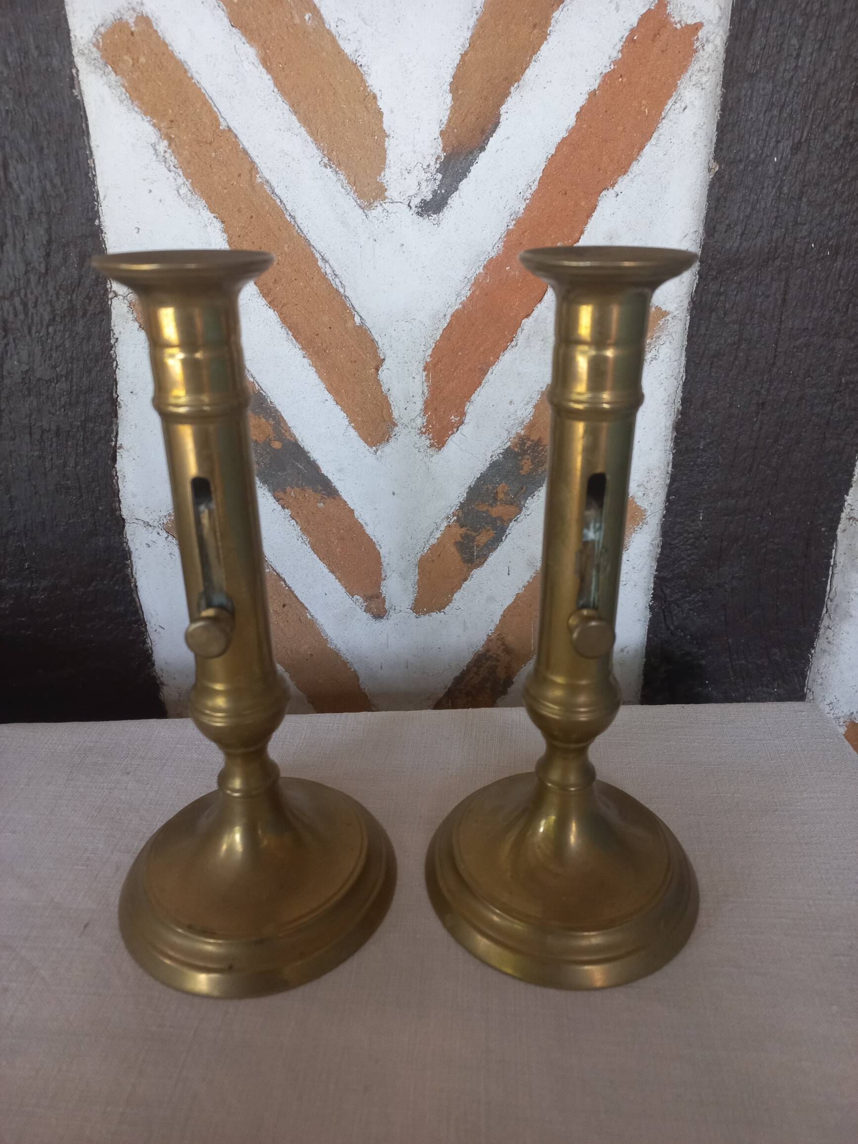 Pair of brass push-button candlesticks