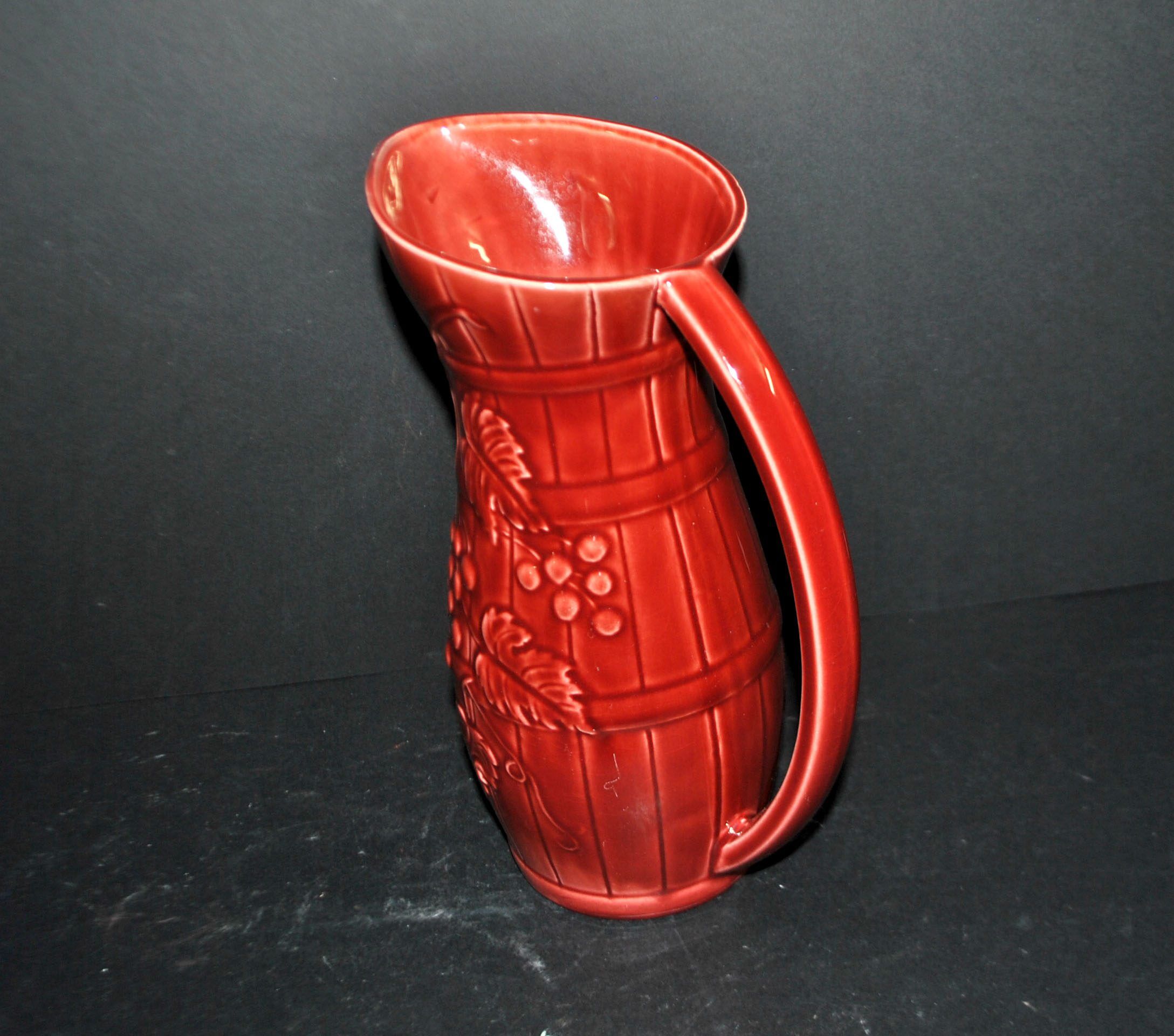 Sarreguemines wine jug in red slipware with grapevine decoration.