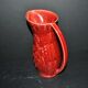 Sarreguemines wine jug in red slipware with grapevine decoration.