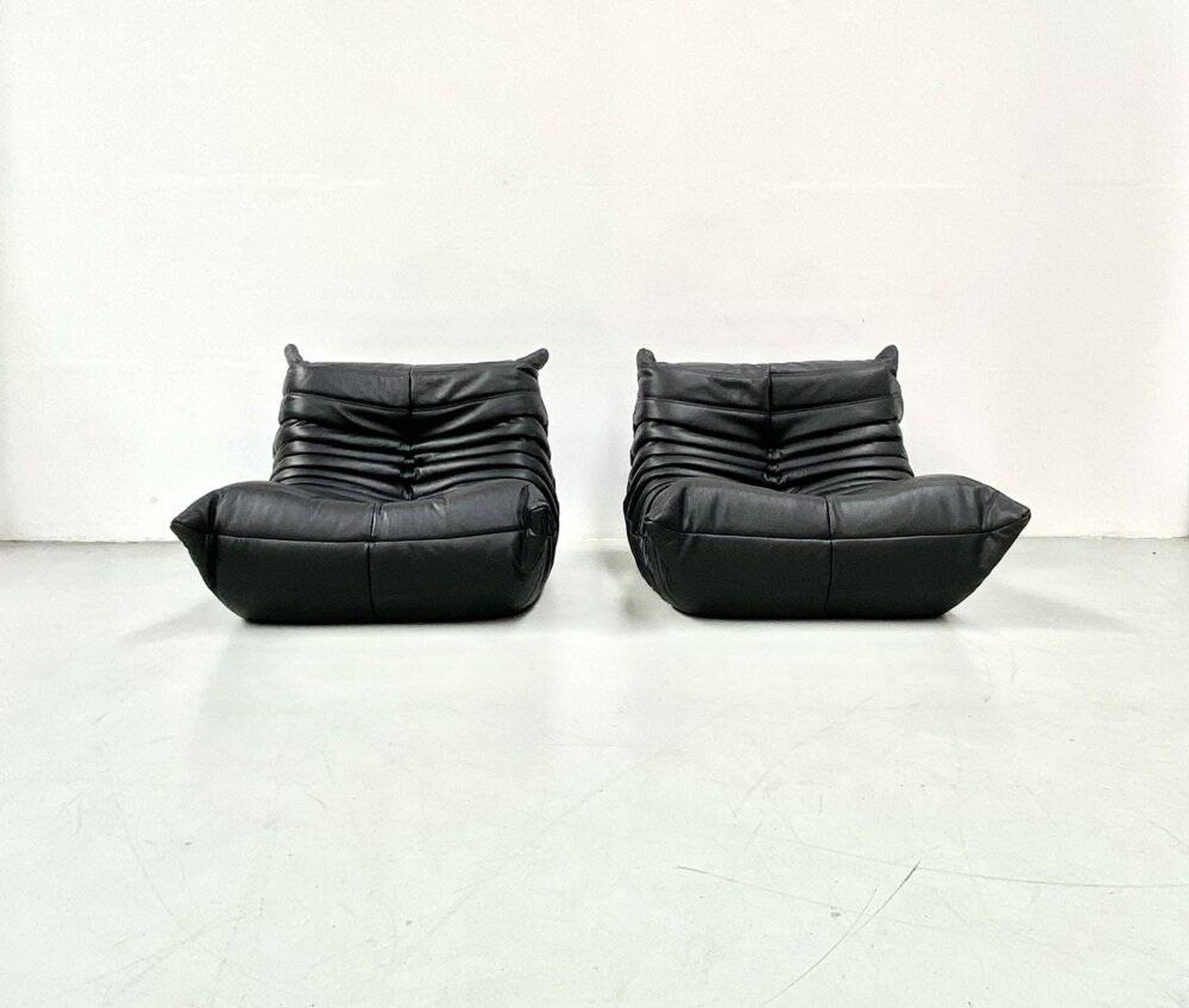 Togo lounge chairs in black leather attributed to Michel Ducaroy for Ligne Roset, set of 2