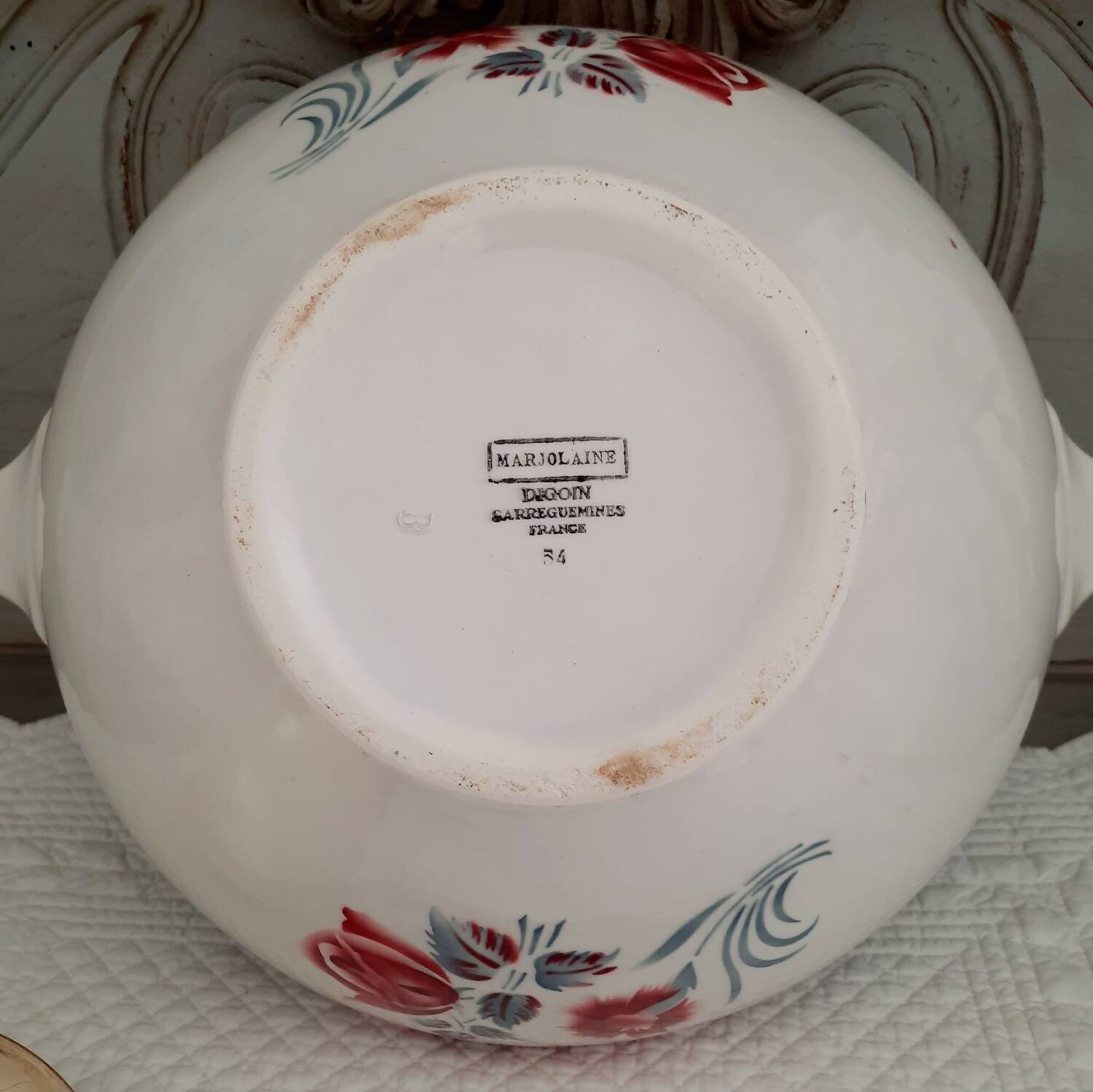 Mismatched old soup plates accompanied by a soup tureen