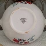 Mismatched old soup plates accompanied by a soup tureen