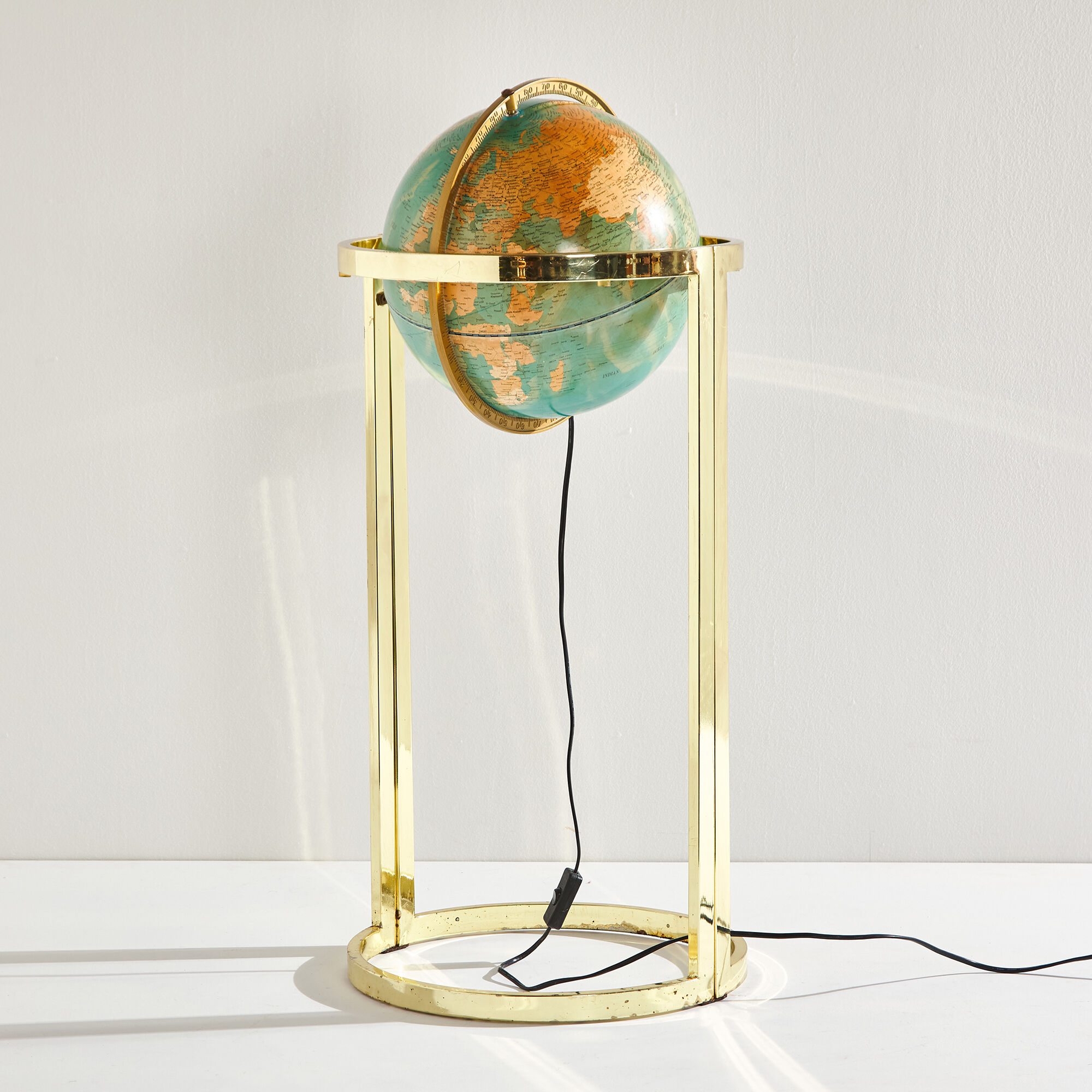 Illuminated globe on brass frame, 1980s