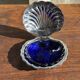 Vintage silver-plated shell butter dish with blue bowl.