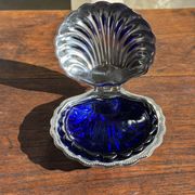 Vintage silver-plated shell butter dish with blue bowl.