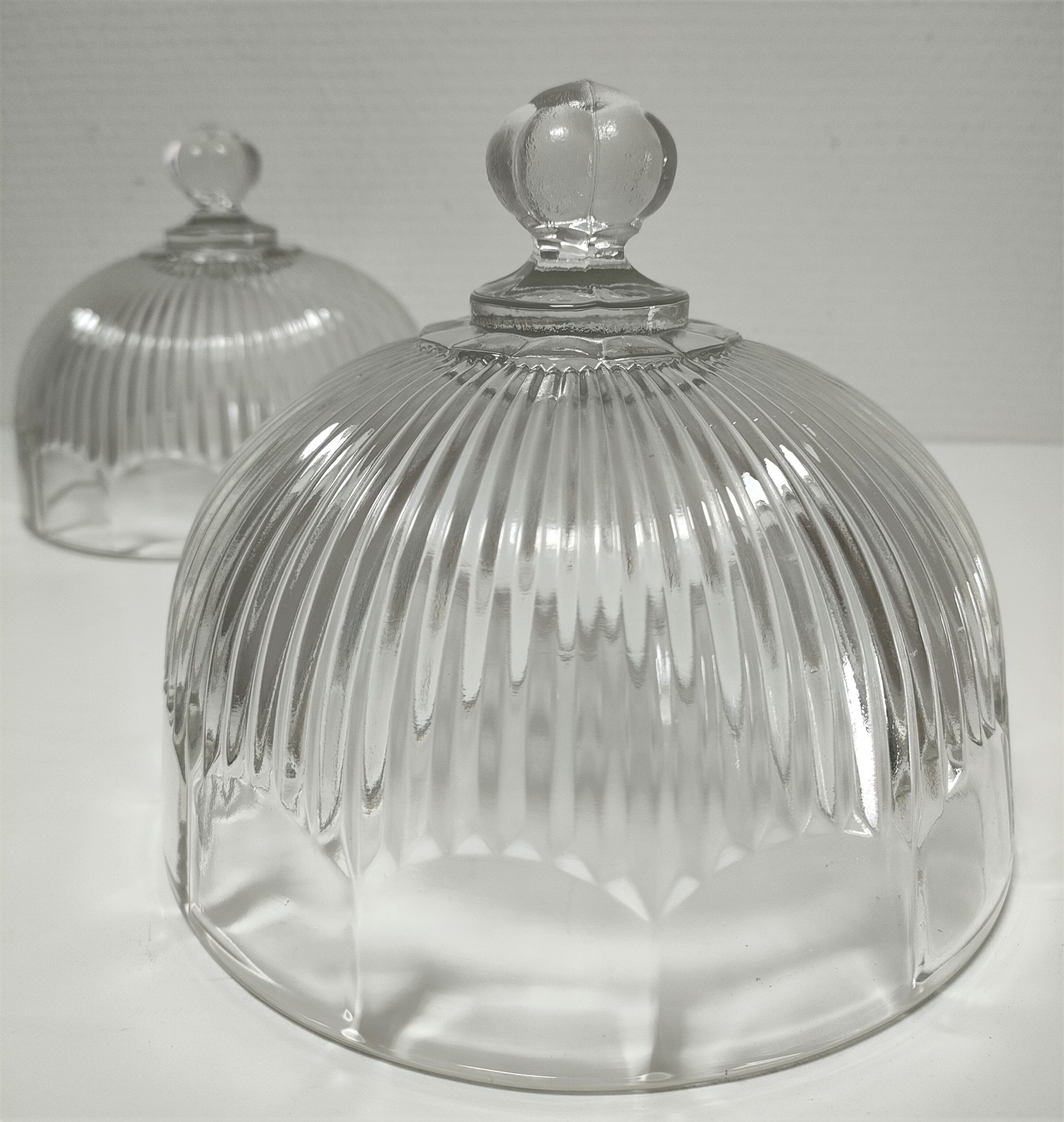 Two cheese bells molded pressed glass striated Art Deco style early twentieth century