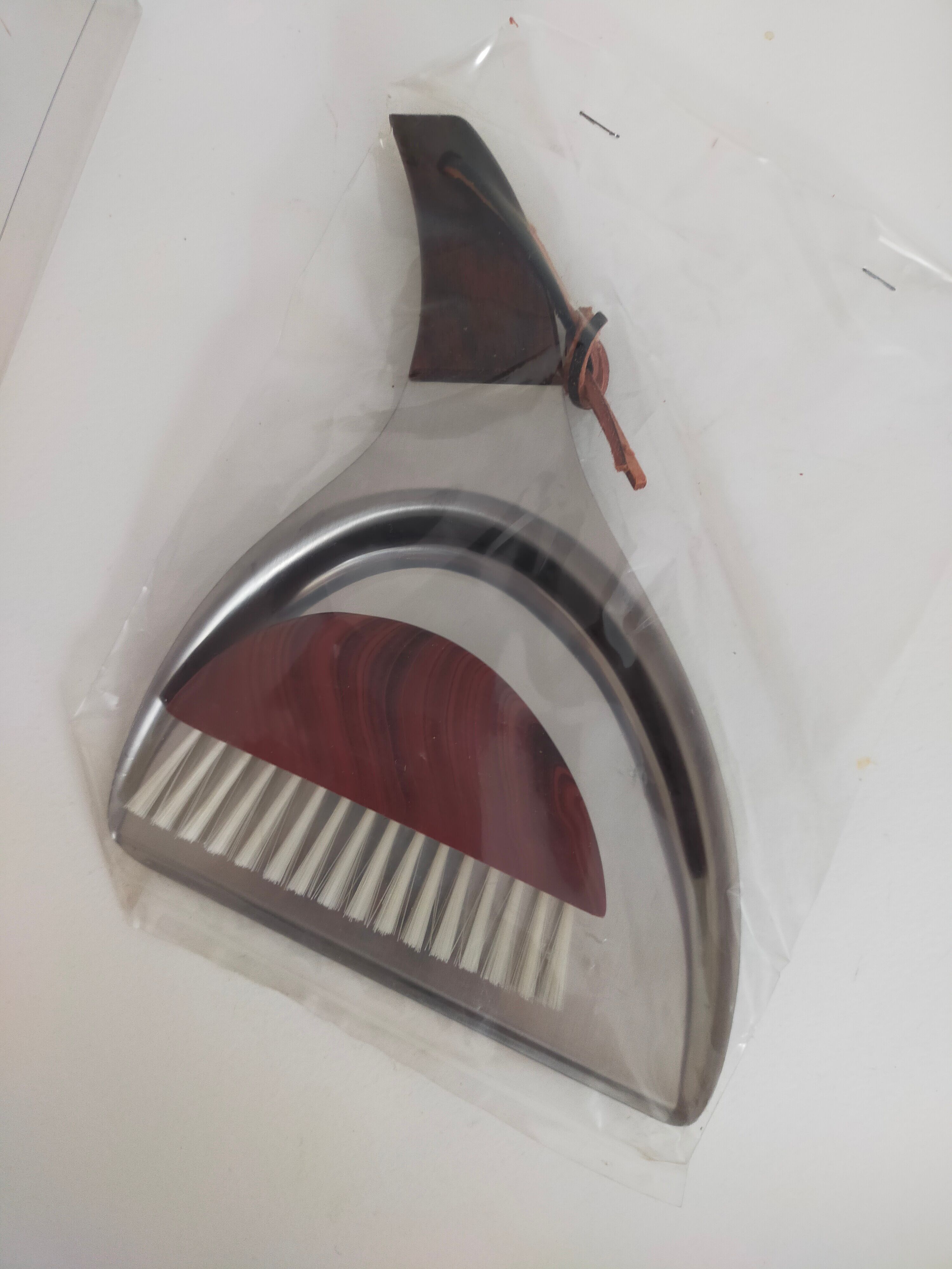 Picks up new vintage shovel and sweeper crumbs