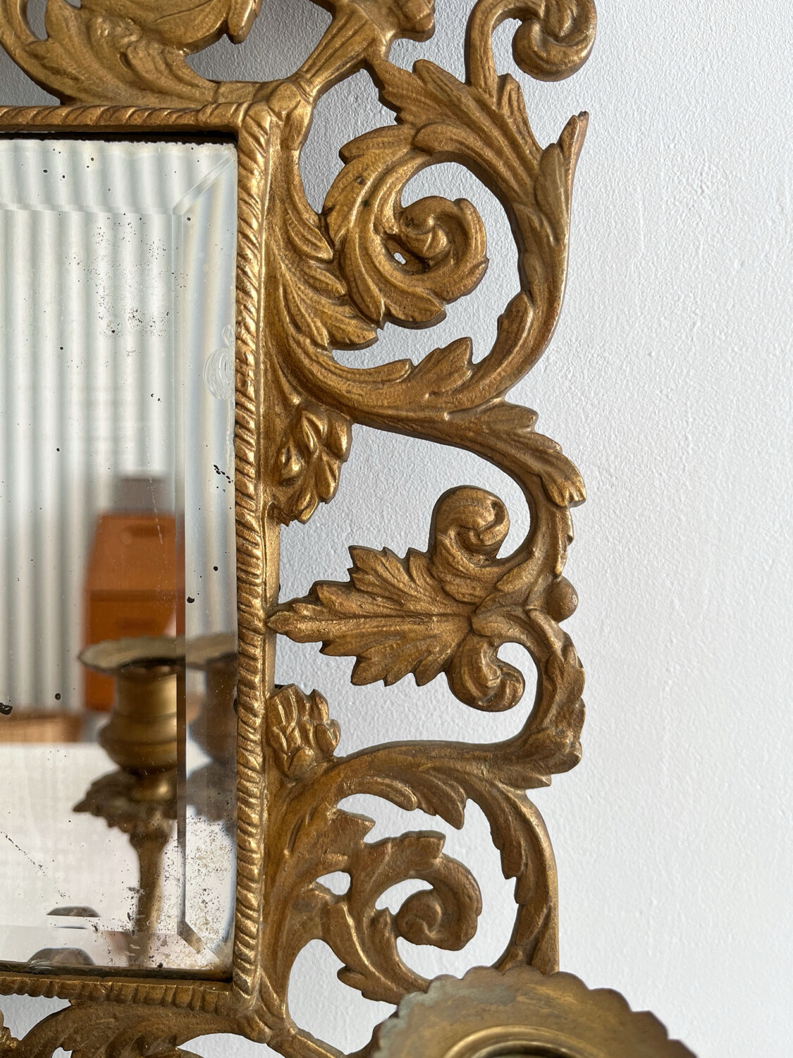 Bevelled mirror wall sconce in gilded bronze with 3 candle holders.