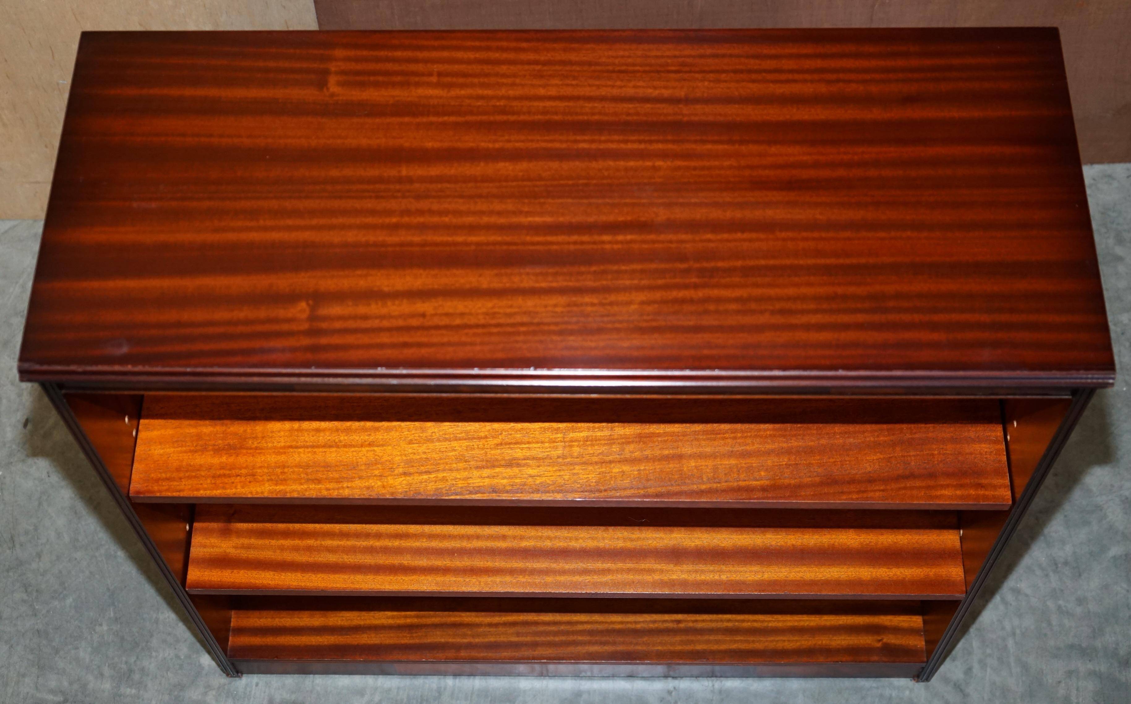 Pair of open low bookshelves Shaws of London in hardwood.