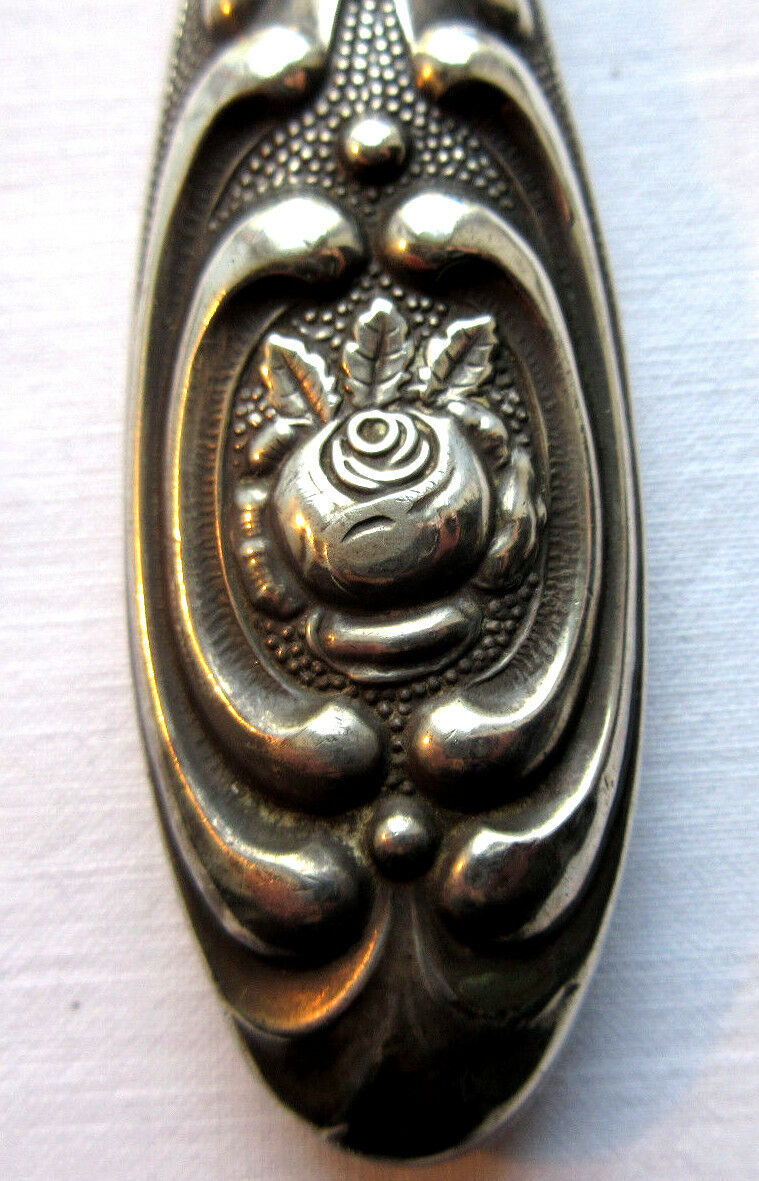 Art Nouveau hand-facing, mirror in repulsed silver frame, rose decoration 14x27cm