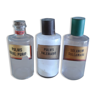 3 transparent glass pharmacy bottles