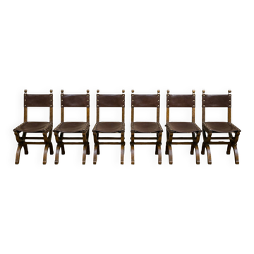 Set of six Renaissance-style chairs in oak and leather.