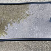 Vintage black tubular coffee table with smoked glass by Yves Boutboul, 1980.