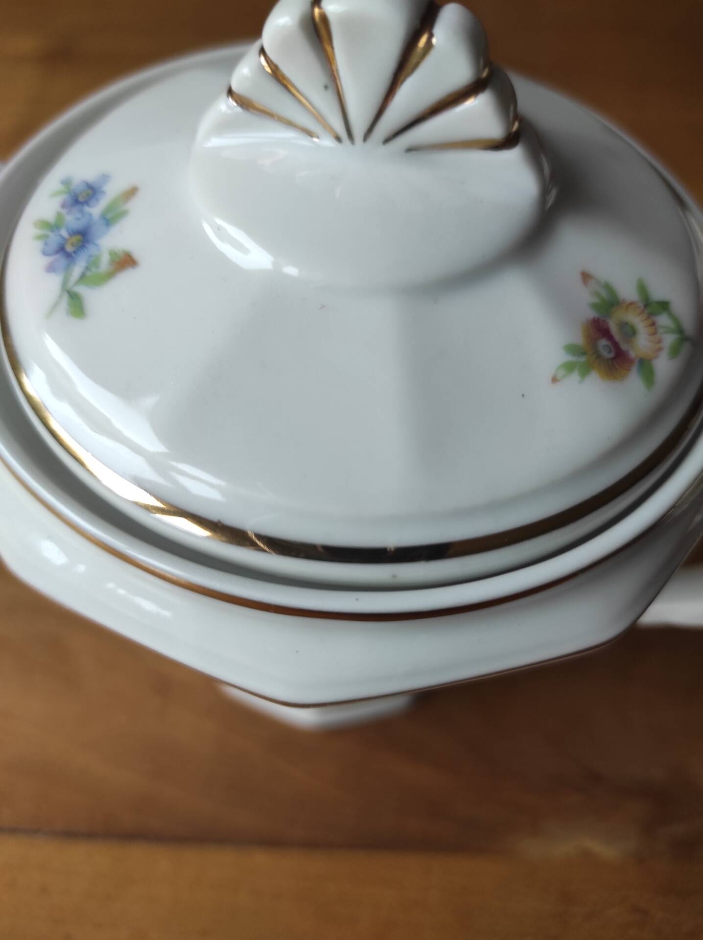 Antique porcelain sugar bowl with a decagonal base.