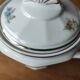Antique porcelain sugar bowl with a decagonal base.