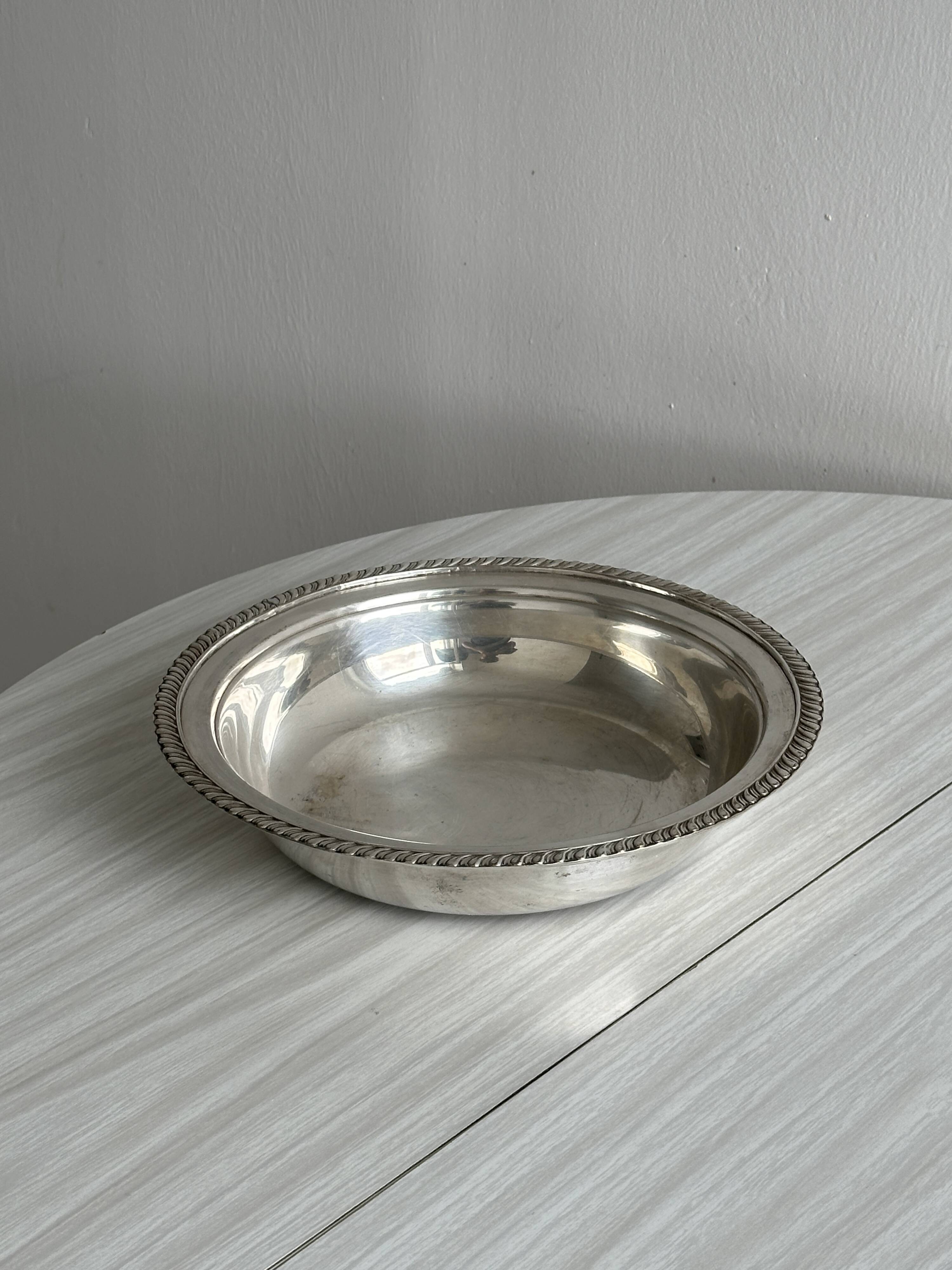 Antique round salad bowl or dish in shiny silver metal