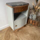Pair of mismatched art deco bedside tables in green and wood