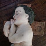 Child on the polychrome plaster cross