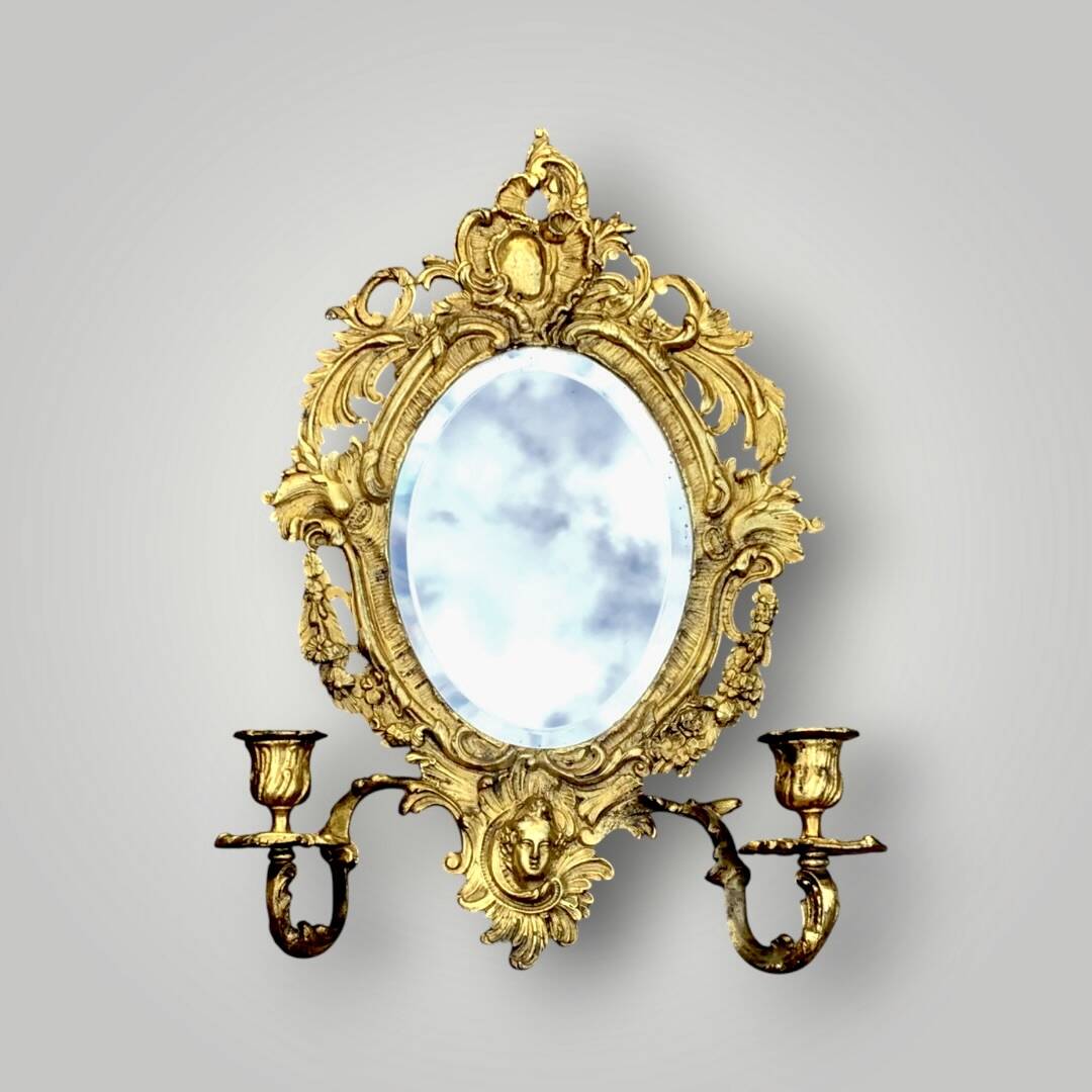 Antique bronze wall sconce with two candlesticks and beveled mirror