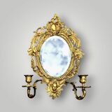 Antique bronze wall sconce with two candlesticks and beveled mirror