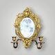 Antique bronze wall sconce with two candlesticks and beveled mirror