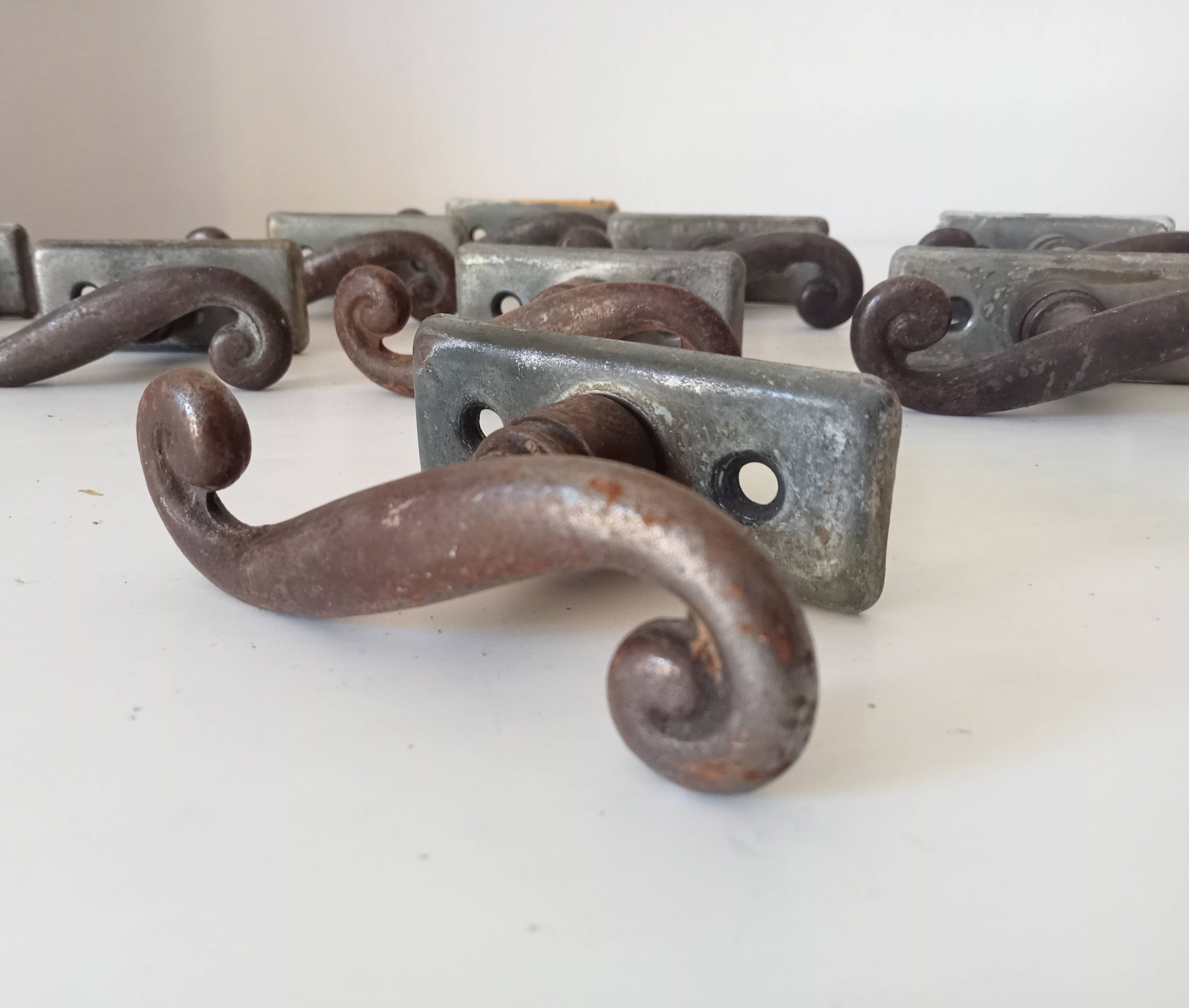 Old window handle with a forged iron cremon.