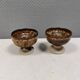 A set of ceramic candle holders in earthy colours.