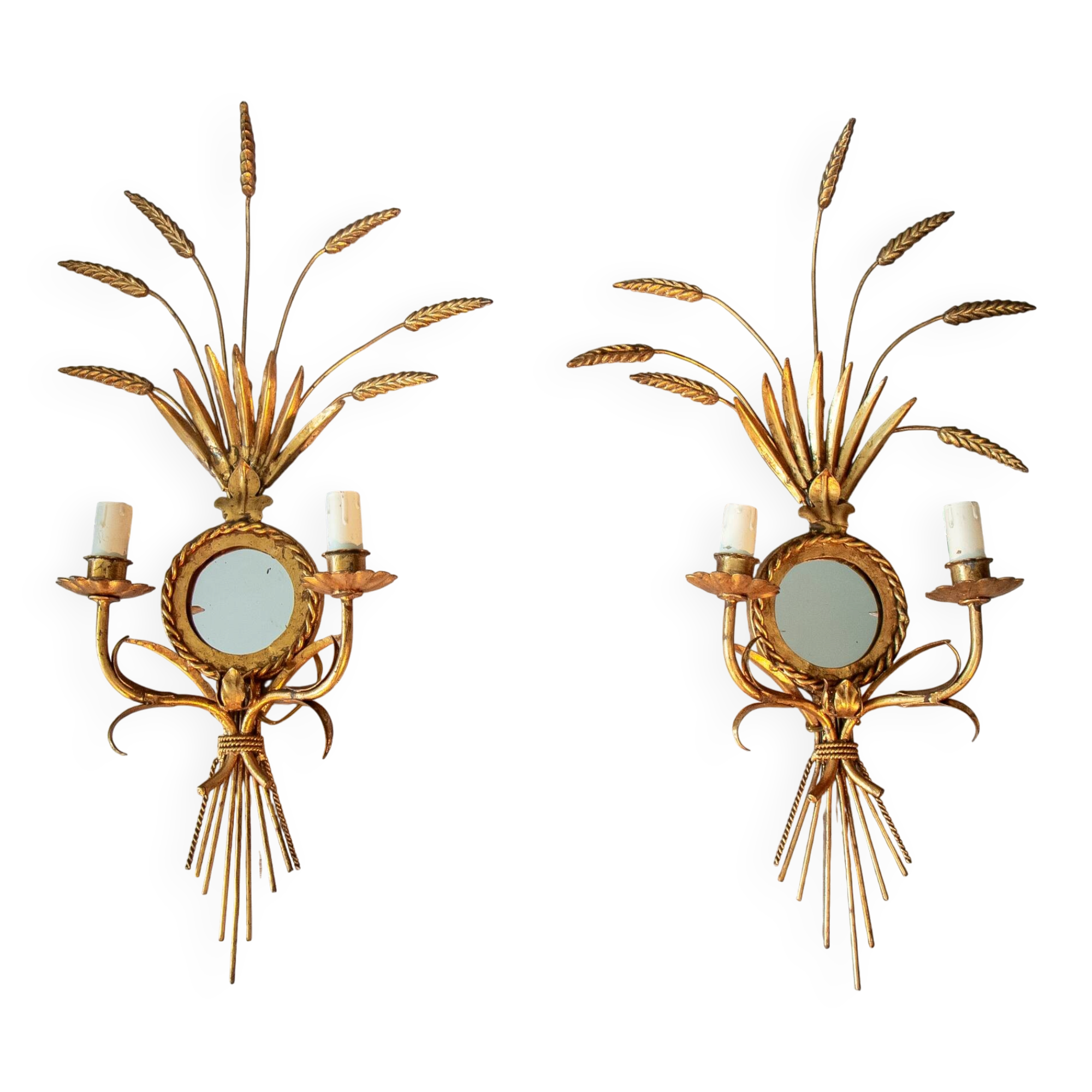 A pair of 1950s wall sconces in gold leaf metal.