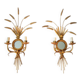 A pair of 1950s wall sconces in gold leaf metal.