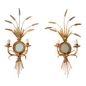 A pair of 1950s wall sconces in gold leaf metal.