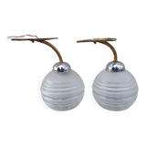 Pair of frosted glass wall lights with brass attachments, circa 1970