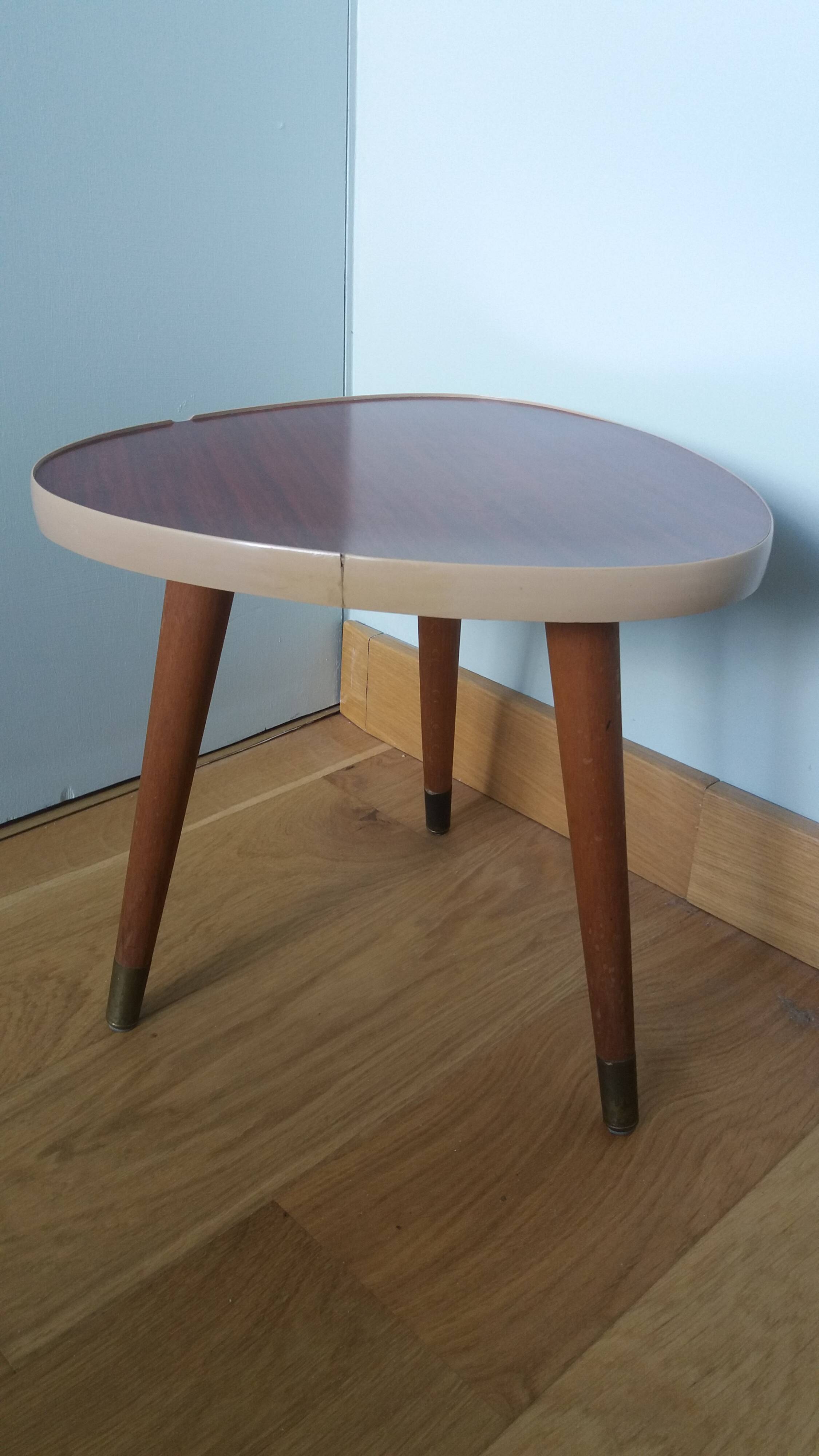 Tripod console table plant stand in the shape of a plectrum.