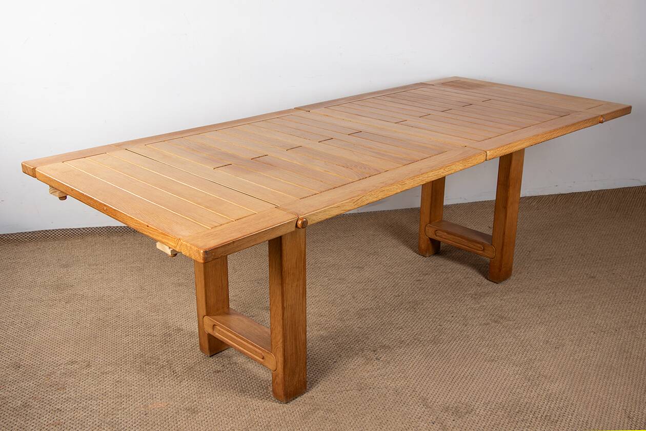 Large extendable dining table in solid oak by Guillerme and Chambron.