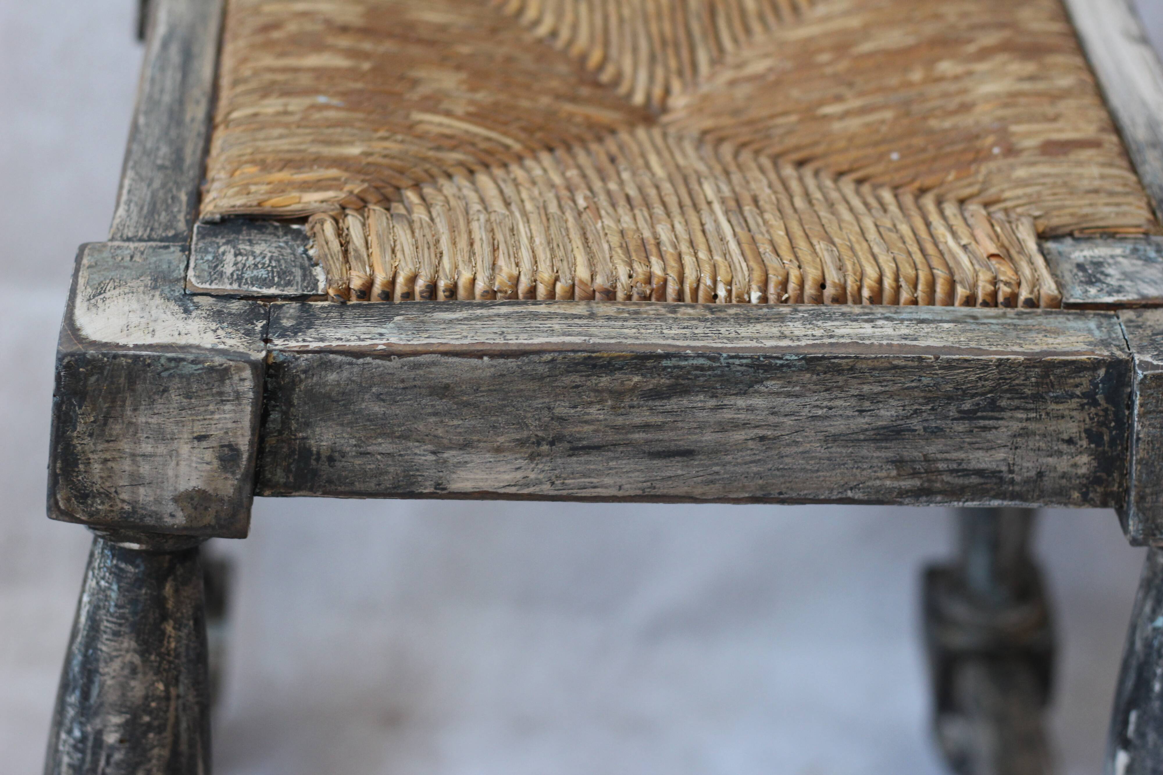 Patinated wooden stool with straw seat