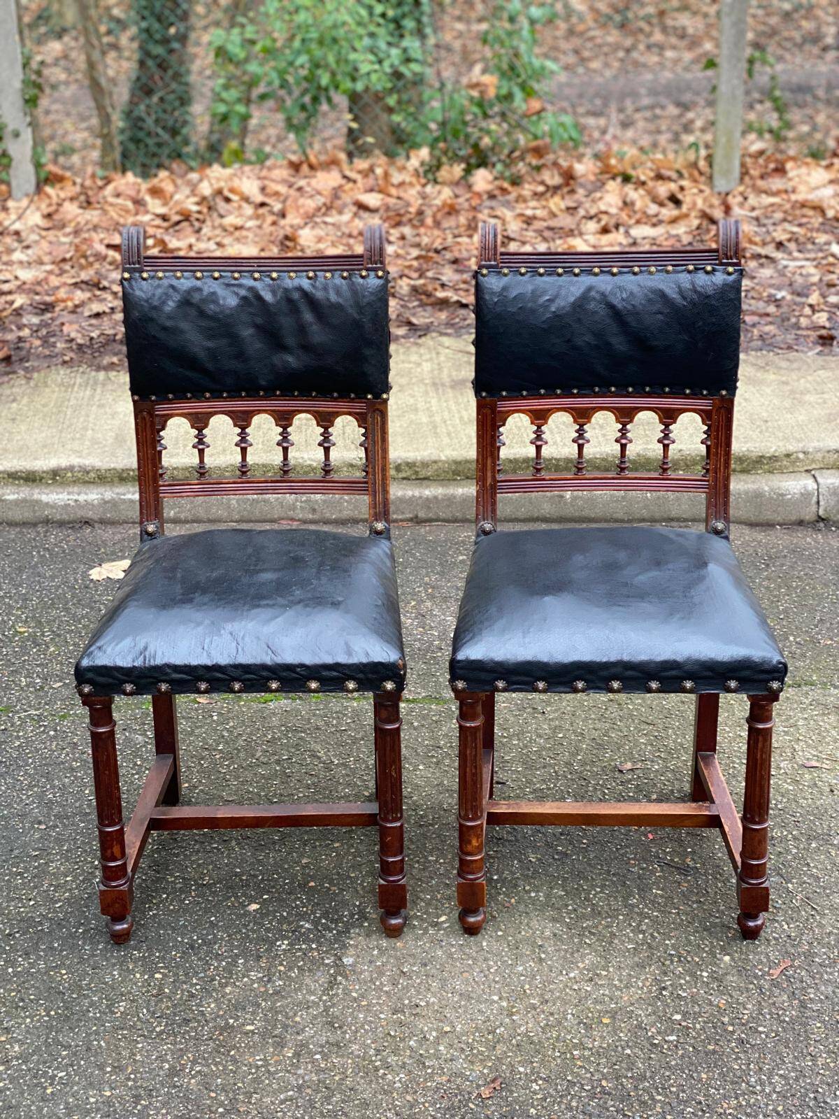 Two 19th-century Henri II chairs in solid wood and black leather upholstery