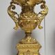 Rare pair of carved and gilded wooden vases, with a refined style inspired by the Empire.