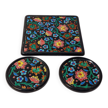 Longwy enamel set, trivet and bottle with floral decoration.