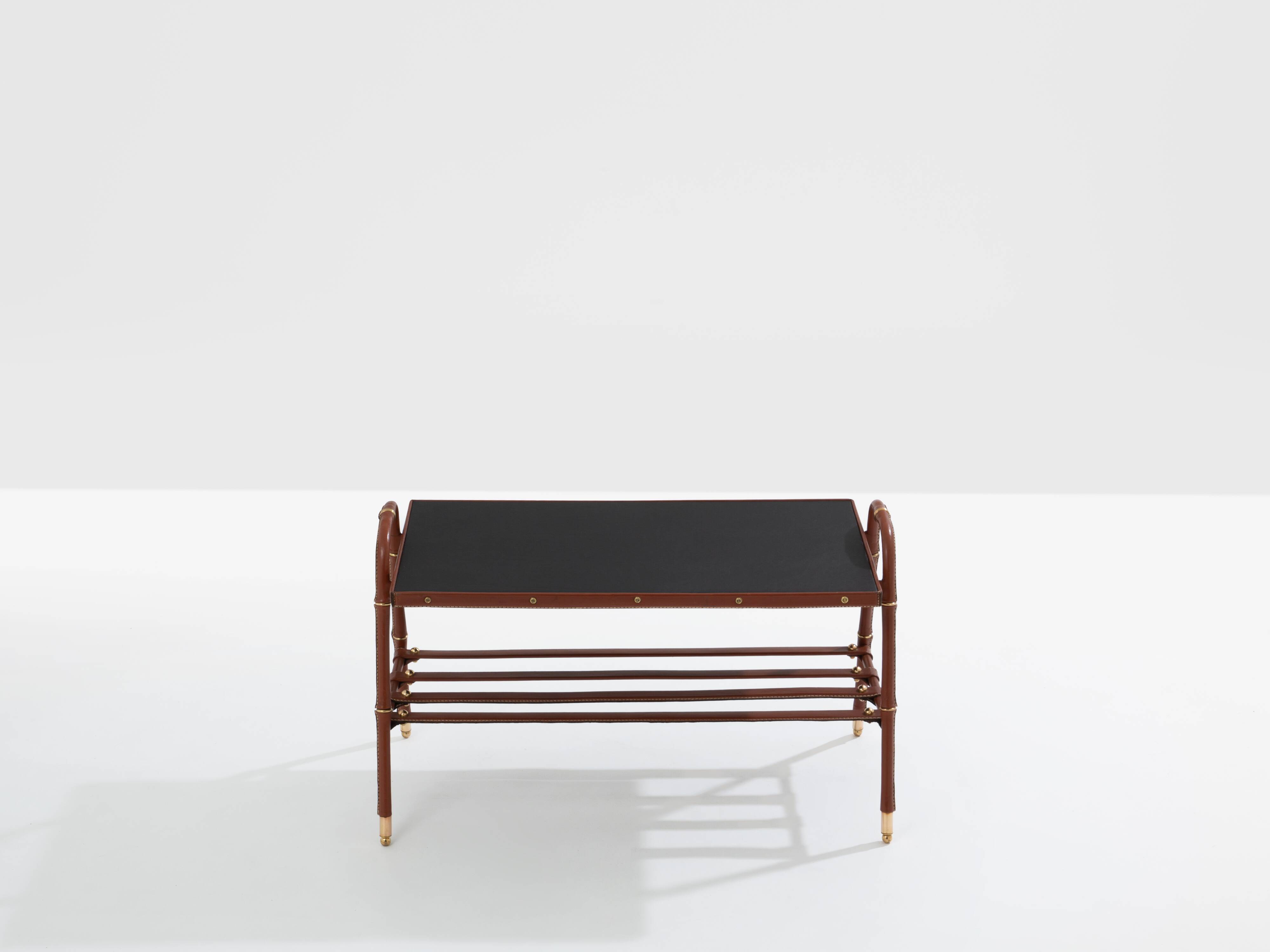 Jacques Adnet coffee table in red saddle-stitched leather and brass, 1950s