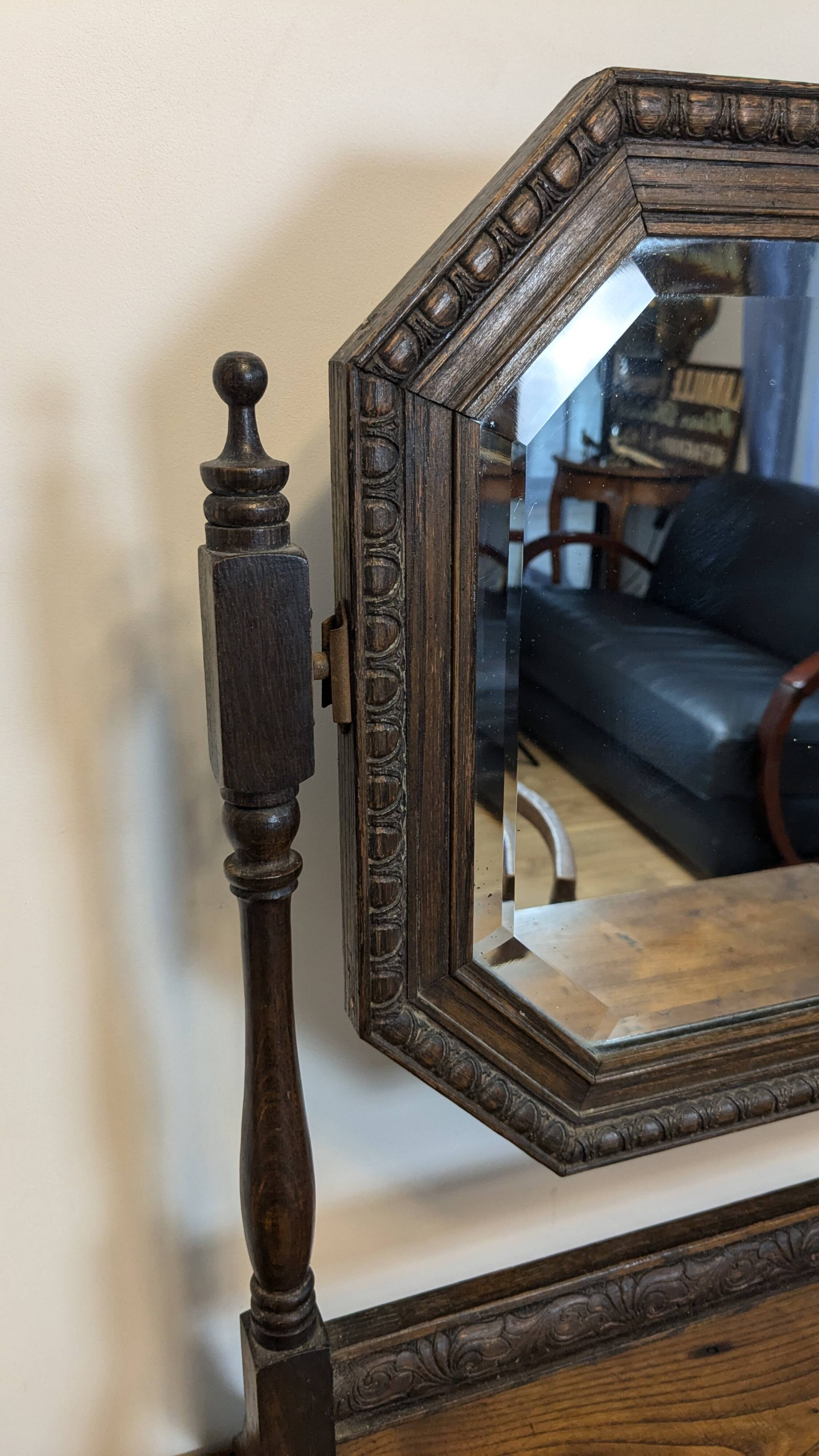 Antique beveled octagonal vanity mirror in carved wood
