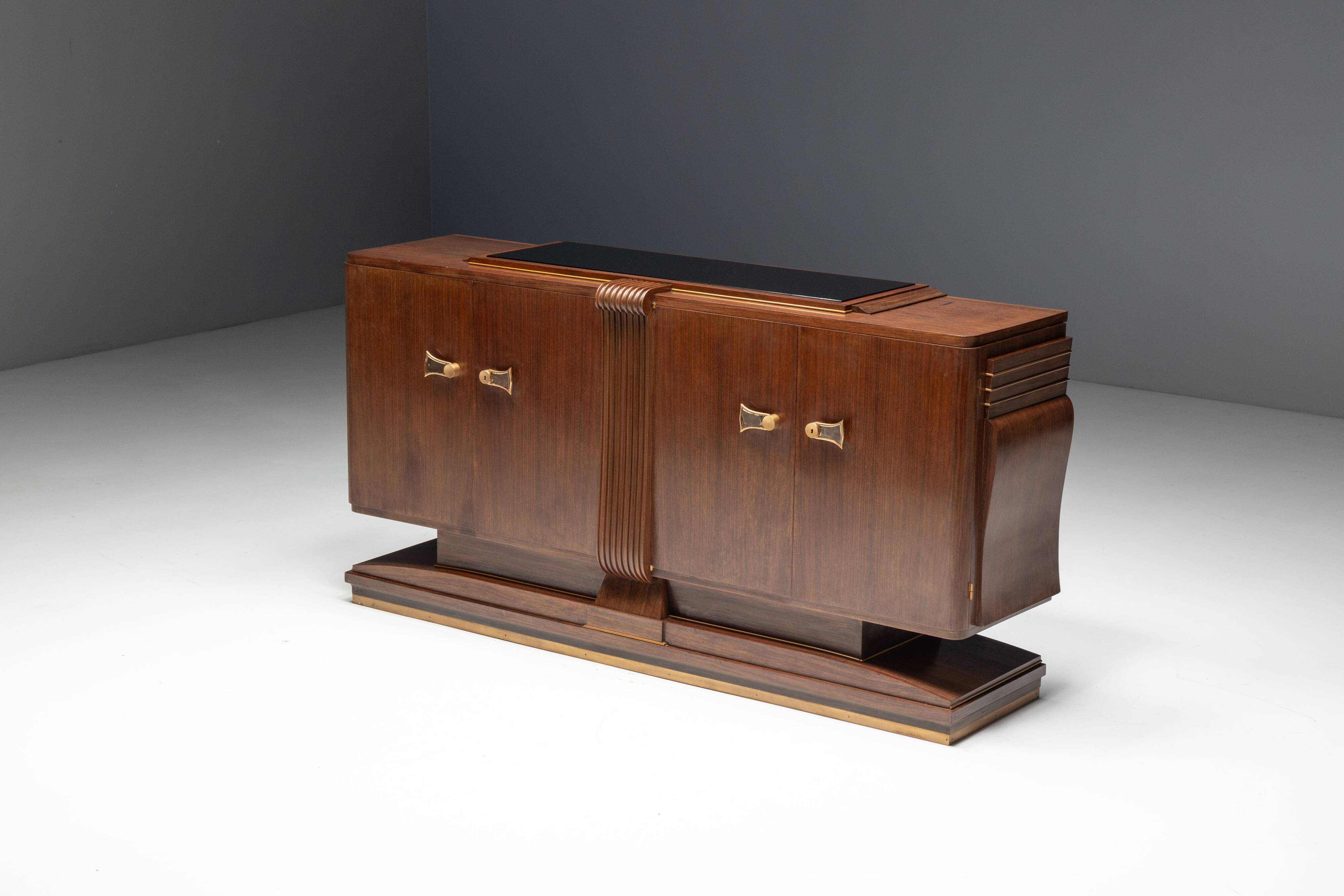 Art Deco walnut sideboard with brass details and sculptural base, France, 1930s