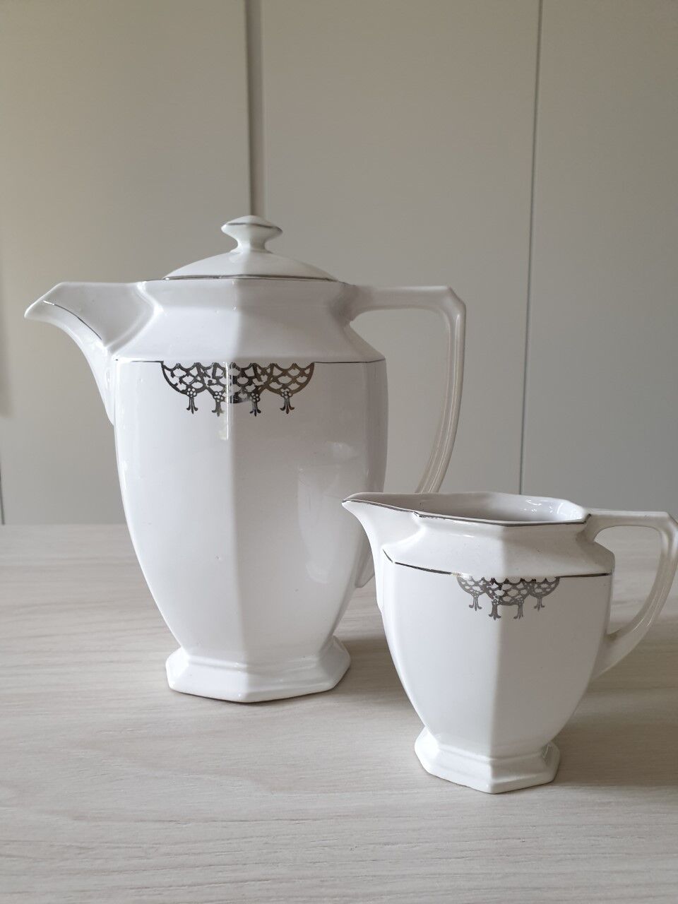 Old coffee maker and its milk pot