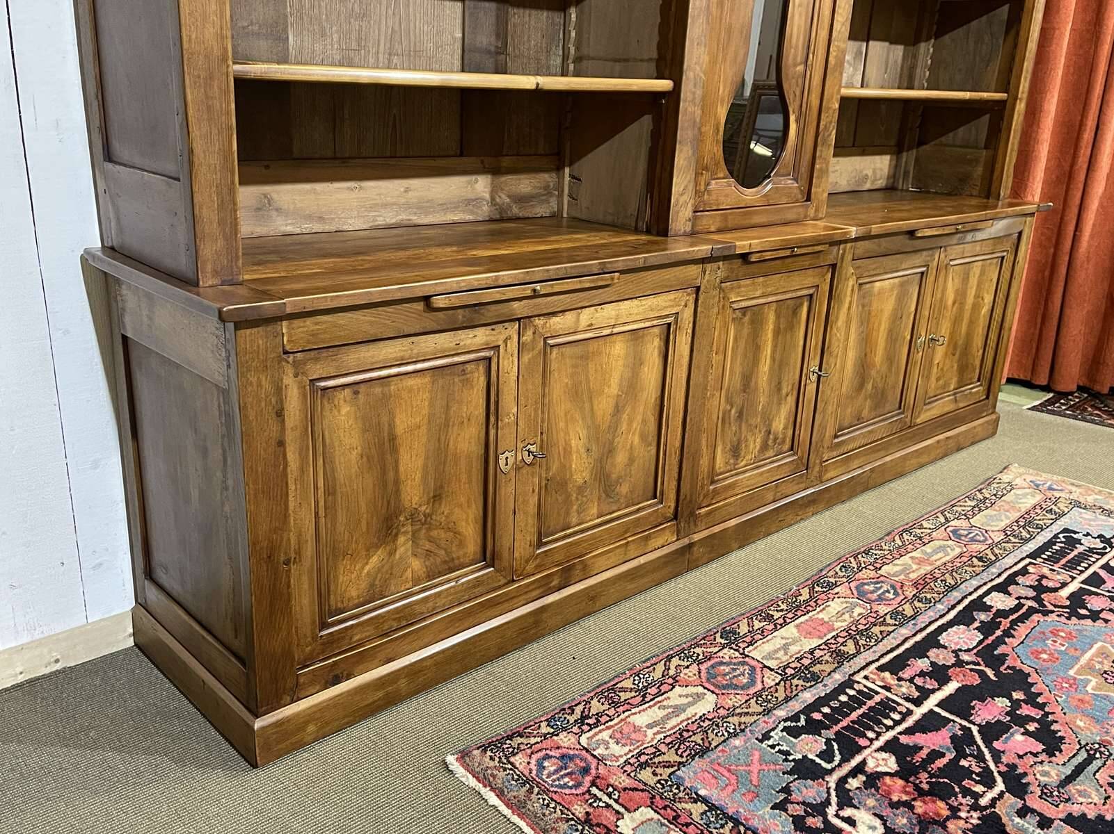 Library in walnut and oak from the early 20th century with its central clock.