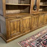 Library in walnut and oak from the early 20th century with its central clock.