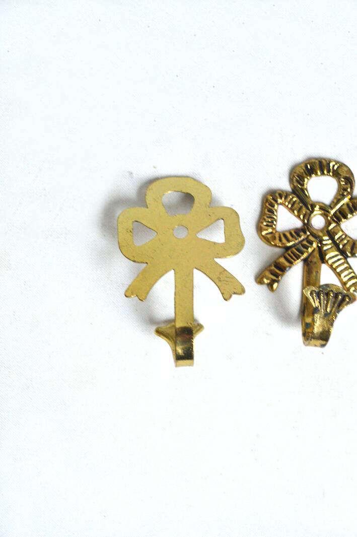 Trio of brass coat hooks