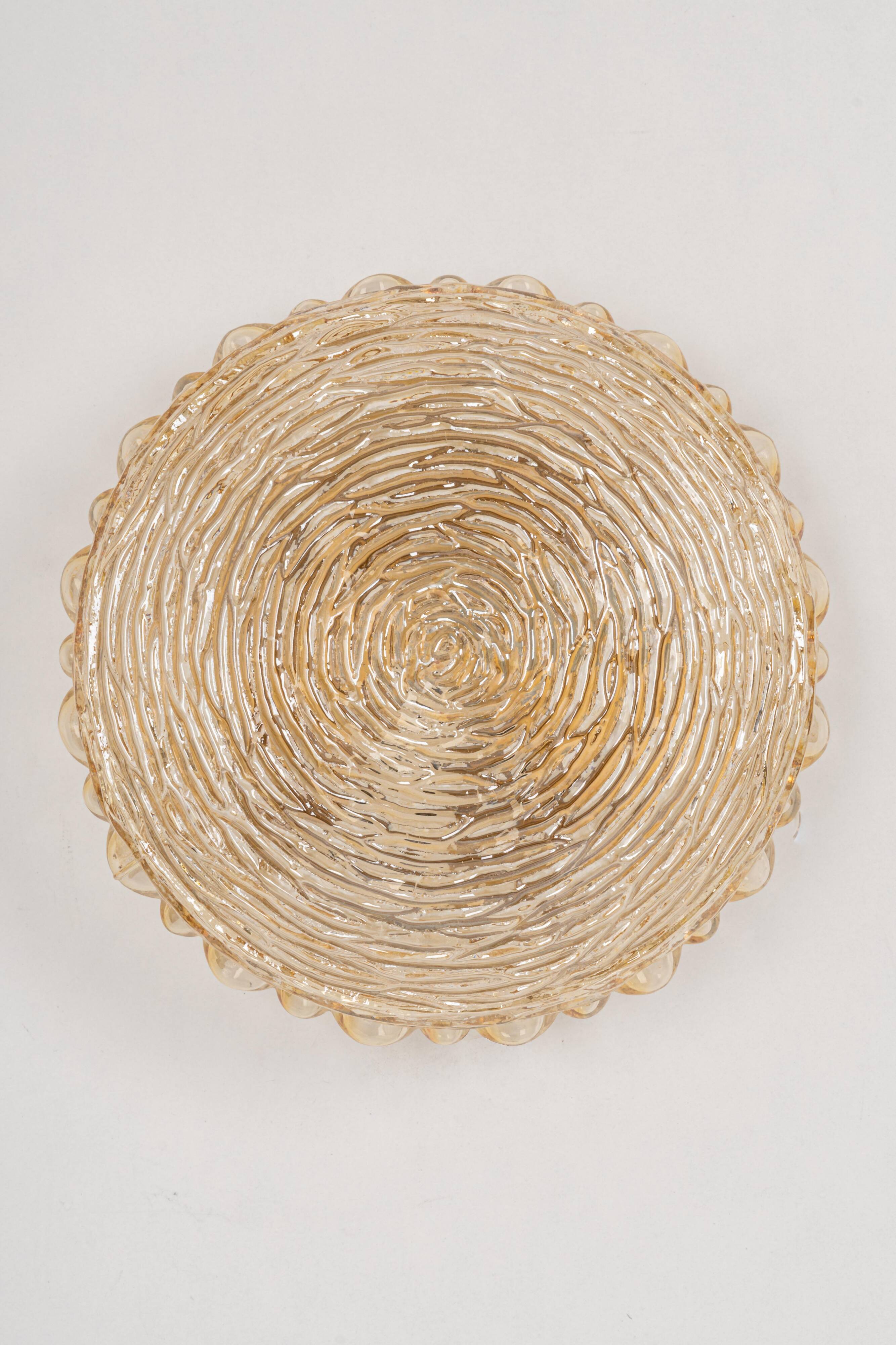 Amber glass wall sconces in the shape of a fingerprint, Germany, 1970s.