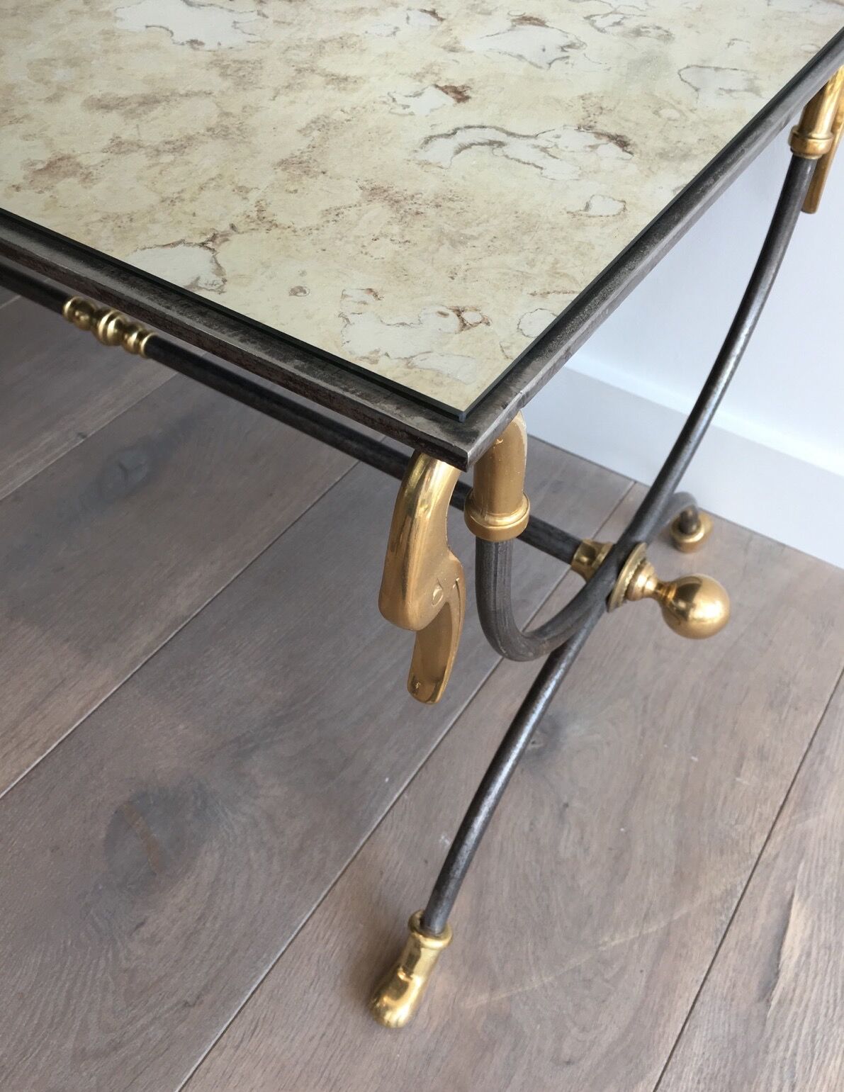 Coffee table in brushed steel and brass