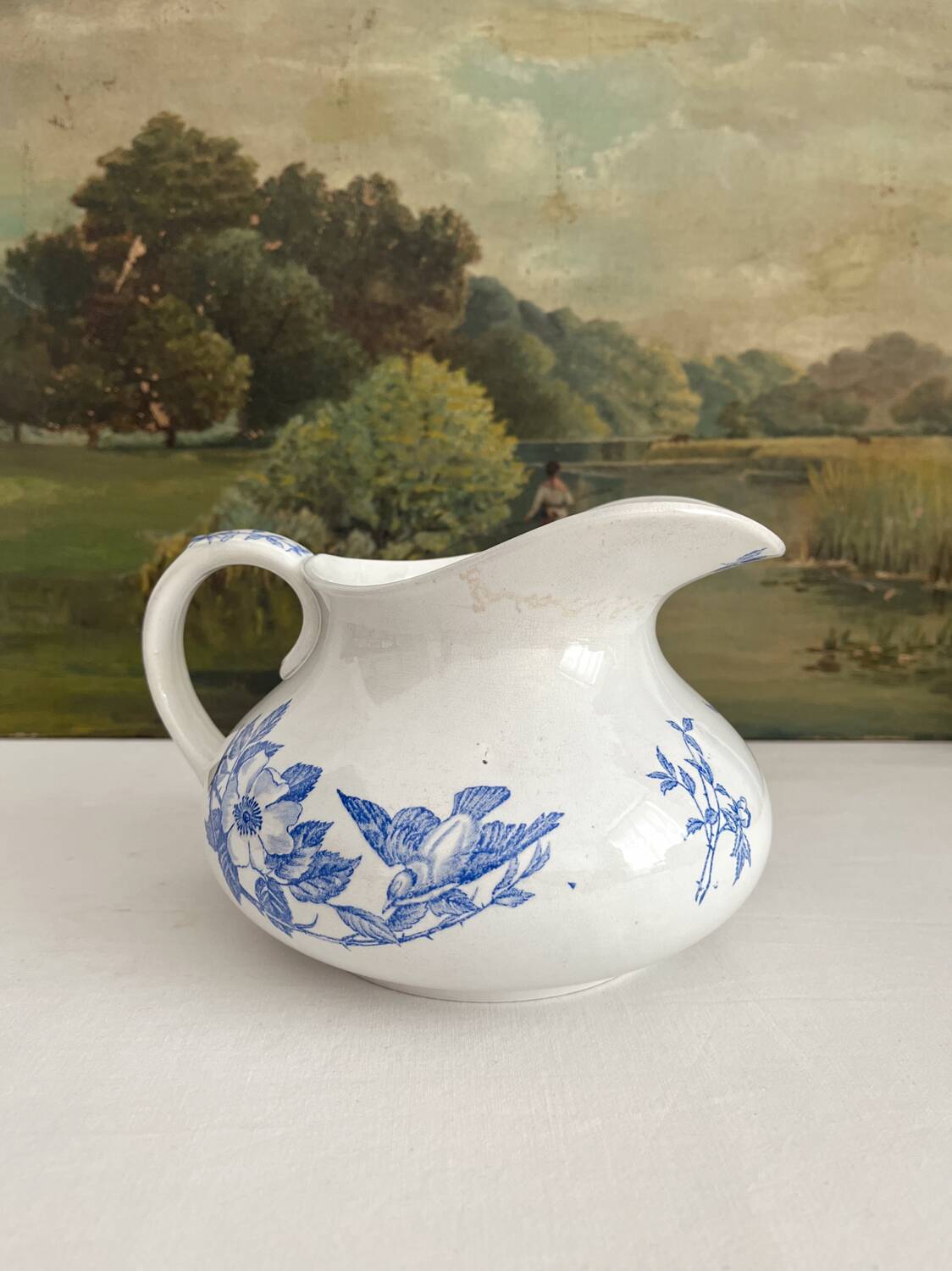 Antique chubby ironstone jug with floral and bird decoration